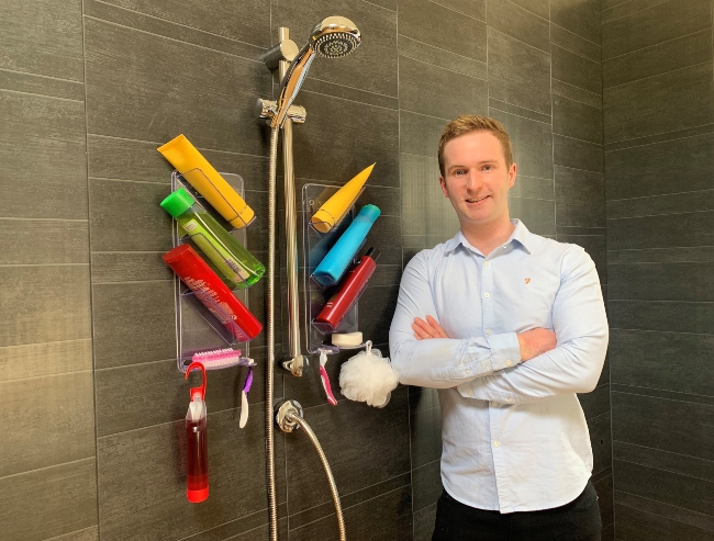 Man standing in shower room with organiser products called Showergem.