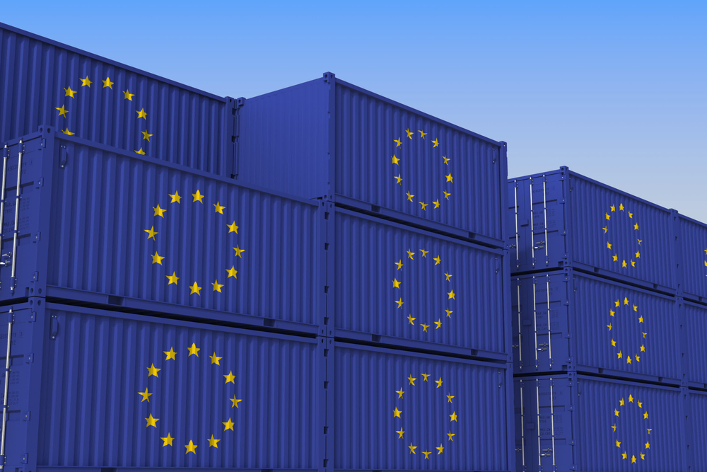 Container yard full of containers with flag of the European Union.