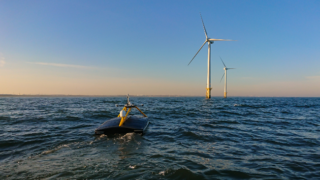 Robot boat approaching wind farm.