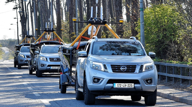 Trucks towing robotic boats.