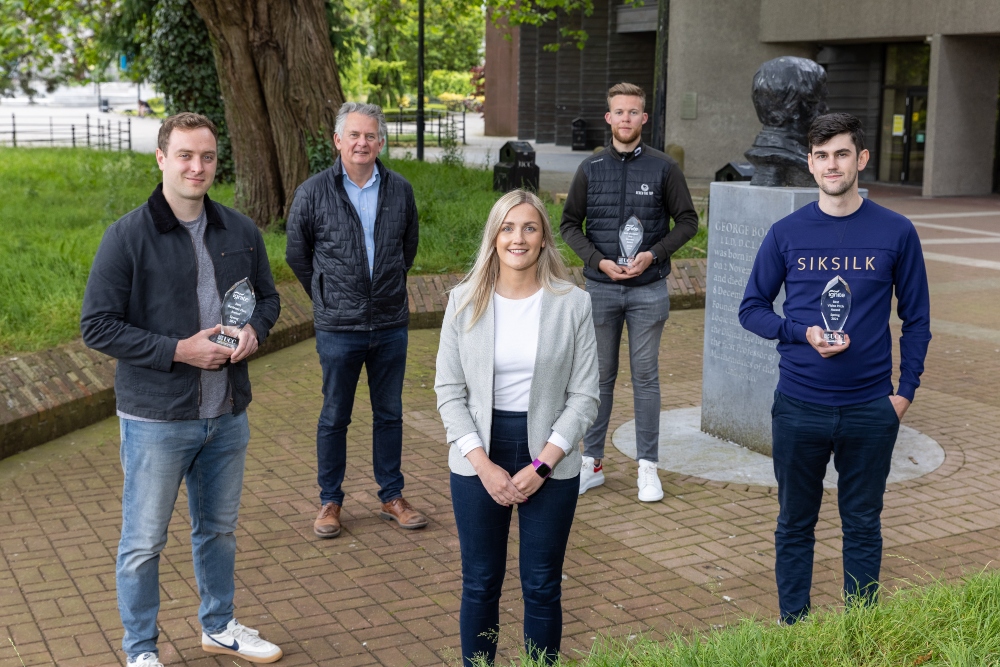 Four men and a woman standing at University College Cork.