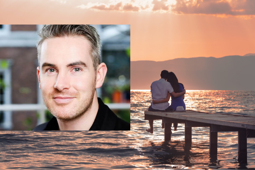Smiling man with short hair inset on an image of a romantic couple sitting at the end of a pier.