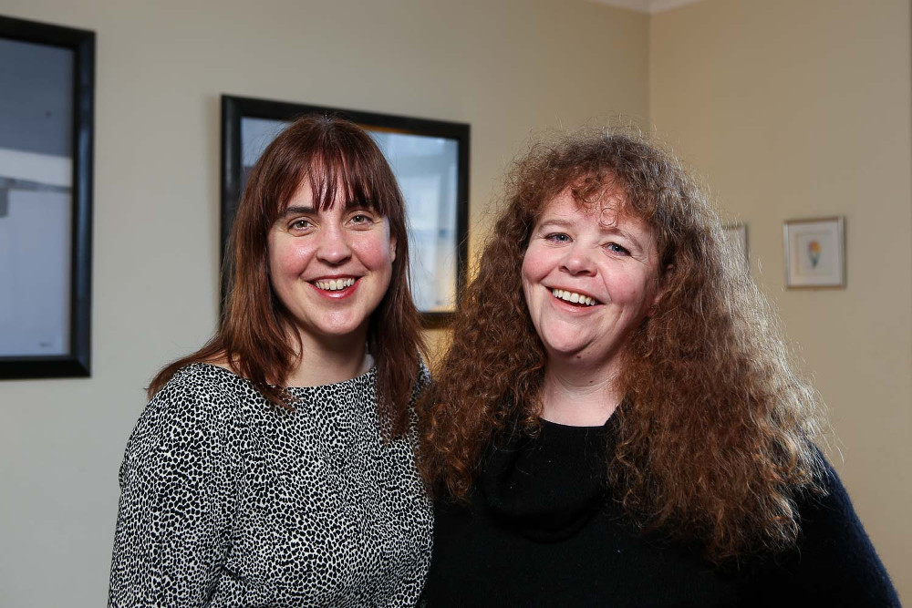 Two women smiling.