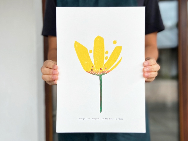 Woman holding linoprint.