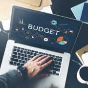 Person on a laptop budgeting marketing spend.