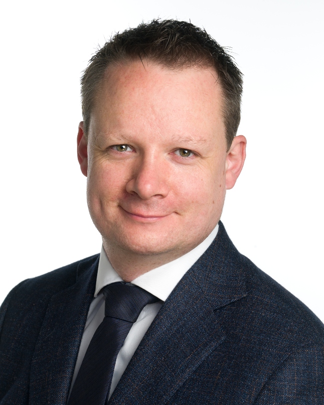 Dark-haired man in suit.