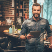 Smiling barbershop owner.