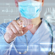A futuristic doctor, a surgeon, looks at a technological digital holographic monitor.
