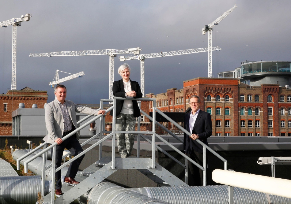 Two men and a woman on a rooftop in Dublin at Guinness Enterprise Centre.