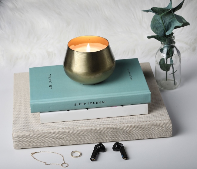 Candle on top of a sleep journal.