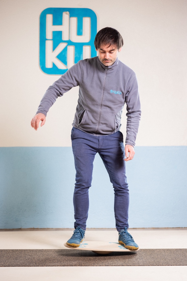 Man standing on balance board.