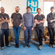 Group of men in a workshop.