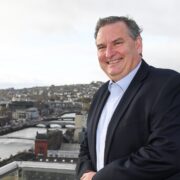 Man at top of building in Cork city.