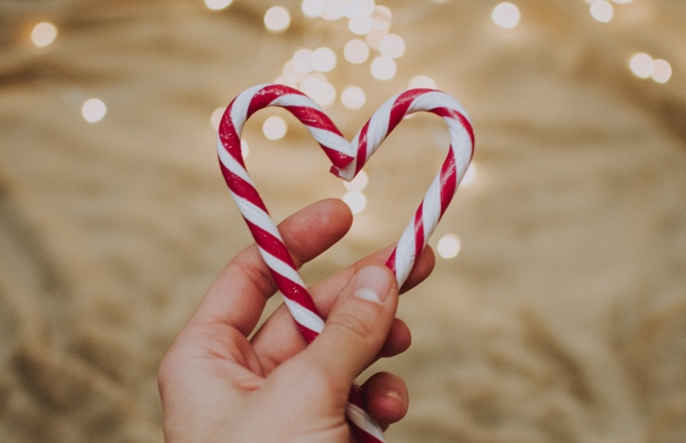 Hand holding candy heart.