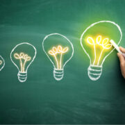 Four lightbulbs signifying journey from small to big ideas.