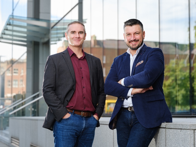 Two men standing in front of an office.