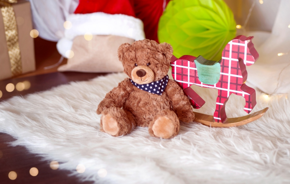 Christmas toys and decorations on a rug.