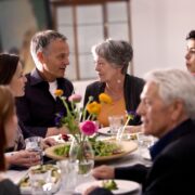 People chatting at dinner table.
