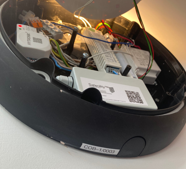 Close up of an internet of things module inside a light fixture.