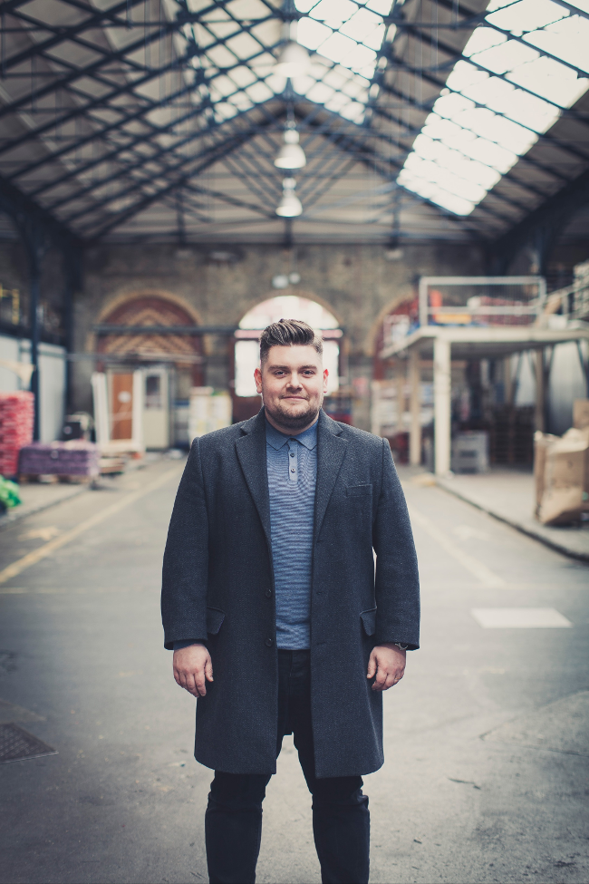 Man standing in warehouse.