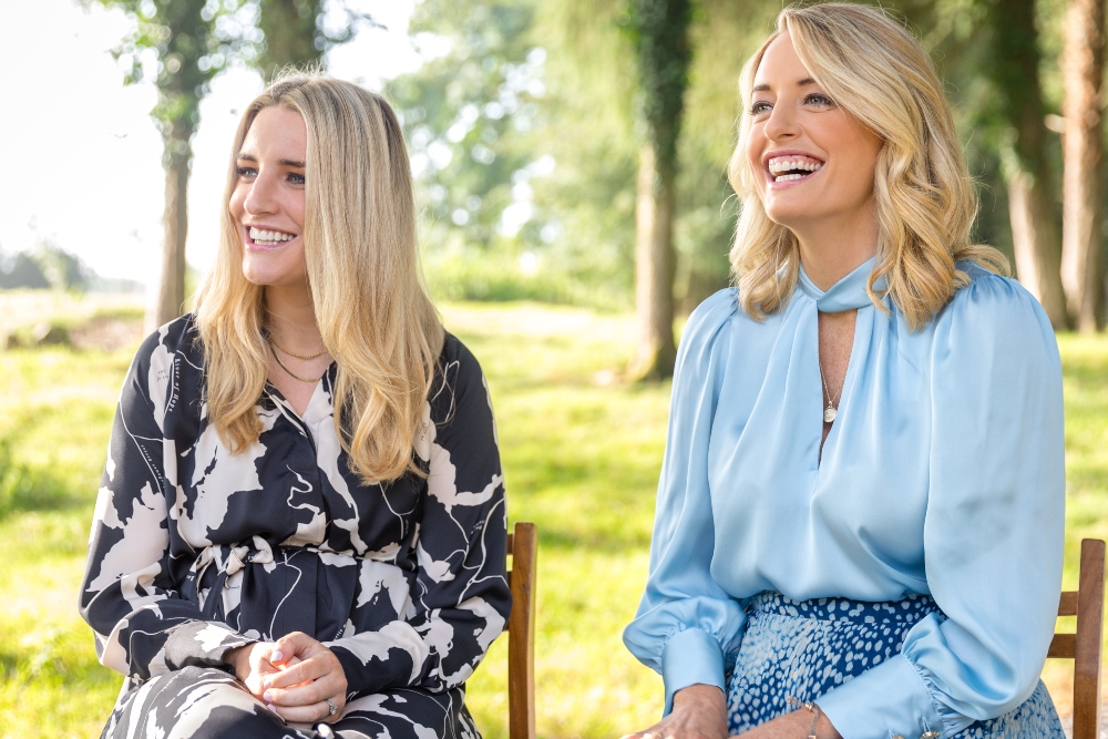 Two women sitting in a garden.