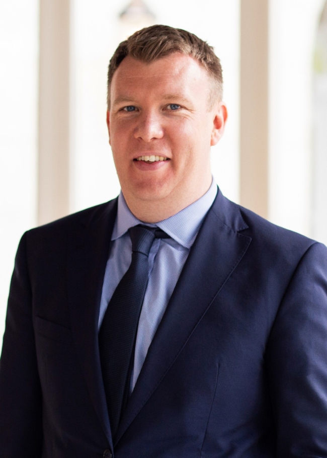 Dark-haired man in suit.