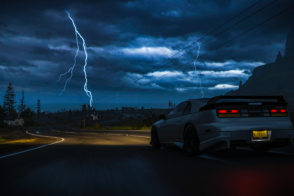 Car driving under stormy sky.