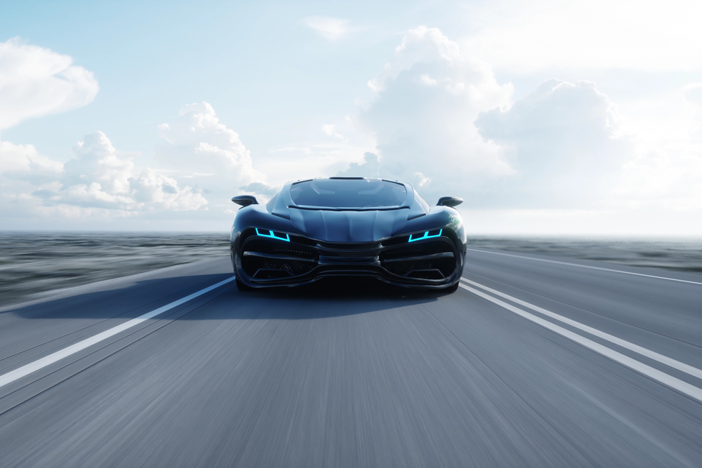 black futuristic electric car on highway in desert.