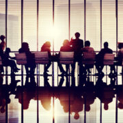 silhouettes of people at a board meeting.