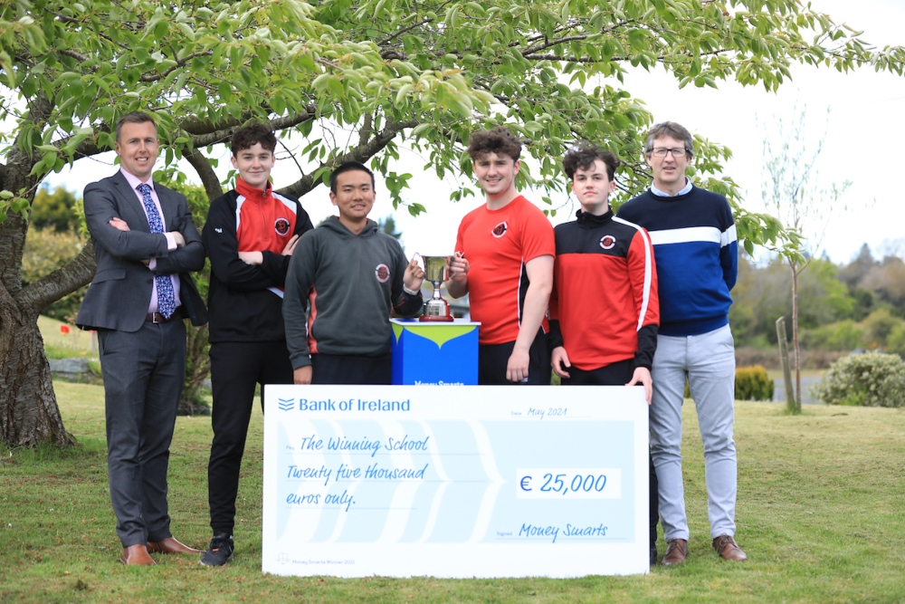 School teachers with students and a cheque.