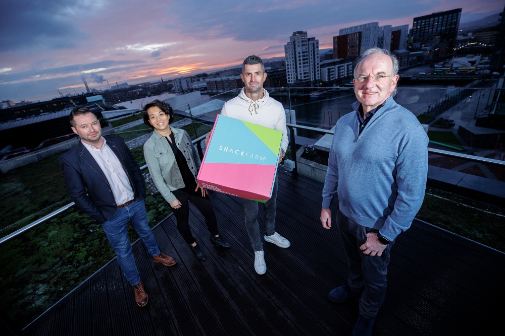 Three men and a woman on a rooftop in Dublin.