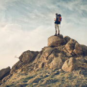 Man scaling a mountain.