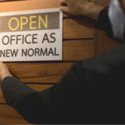 Business owner wears masks to label for open office.