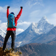 Man standing at the top of a mountain.