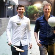 Two men with hurley and football.