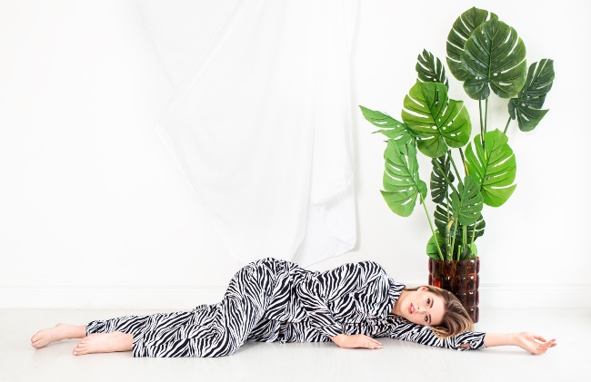 Woman modelling striped luxury pajamas.