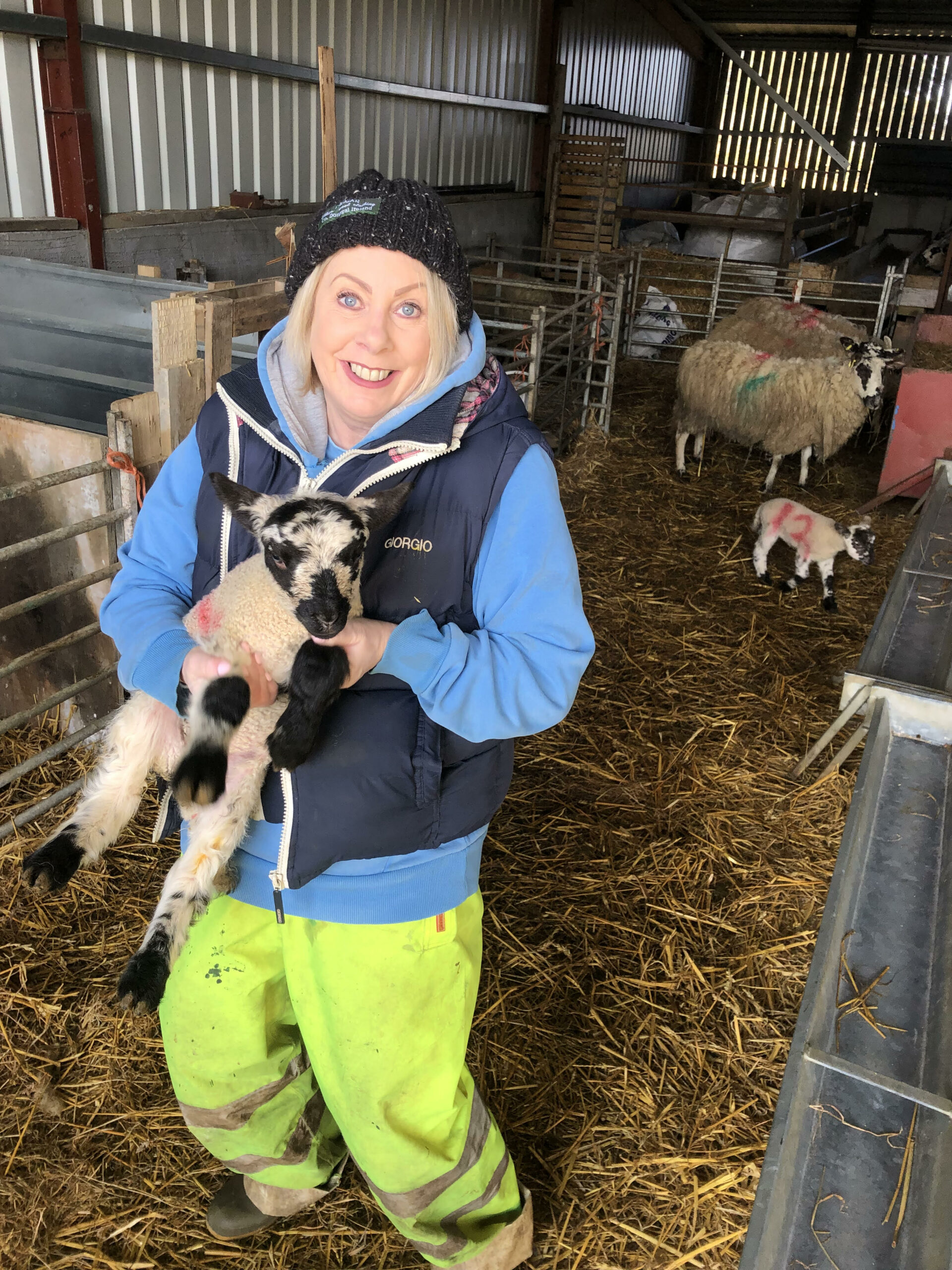 Woman holding a lamb.
