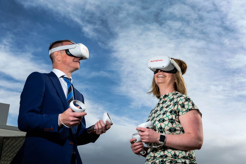 Man and woman wearing VR headsets.