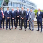 Men and woman outside a building.