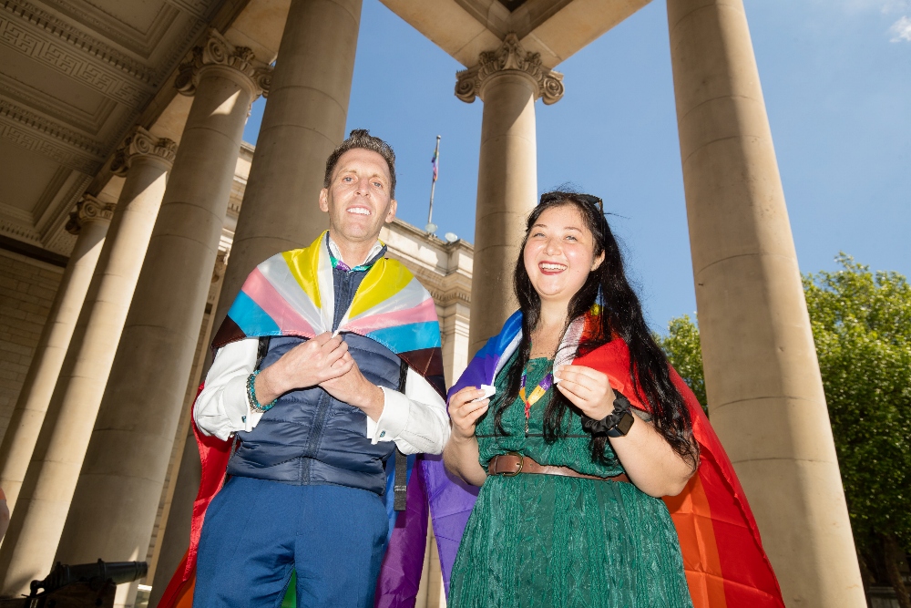 Man and woman in Pride colours.