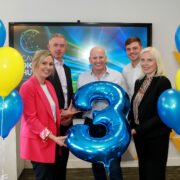 Group of people celebrating with balloons.