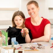 Mother and daughter play with eco toys.