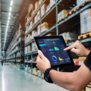 Worker holding tablet in warehouse.