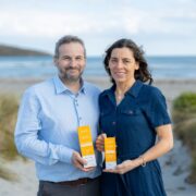 Man and woman beside sea.