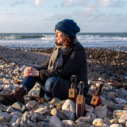 woman sitting on a beach in Donegal.