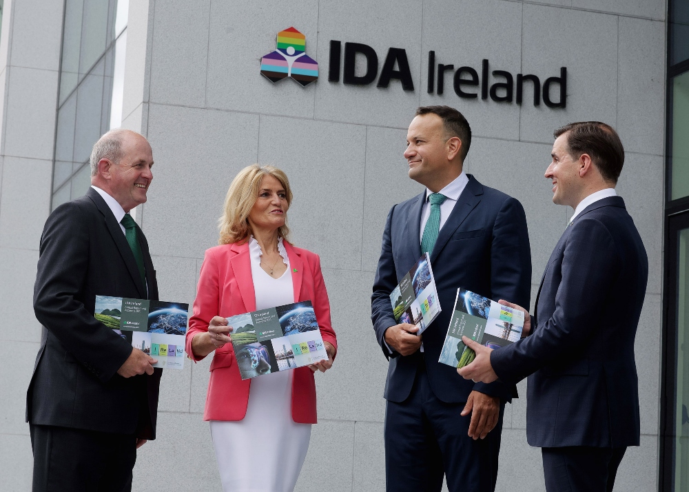 Three men and a woman under IDA Ireland sign.