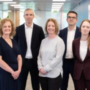 Three women and two men in an office.
