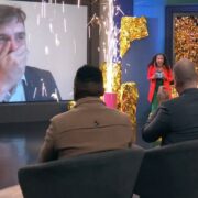 Man on screen in disbelief at winning an award.