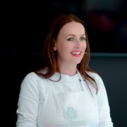 Woman wearing white apron.