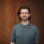 Man in grey sweater.